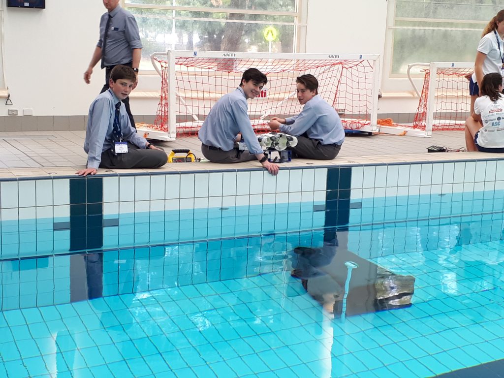 Students with their Remote Operated Underwater Vehicles at the Saints pool