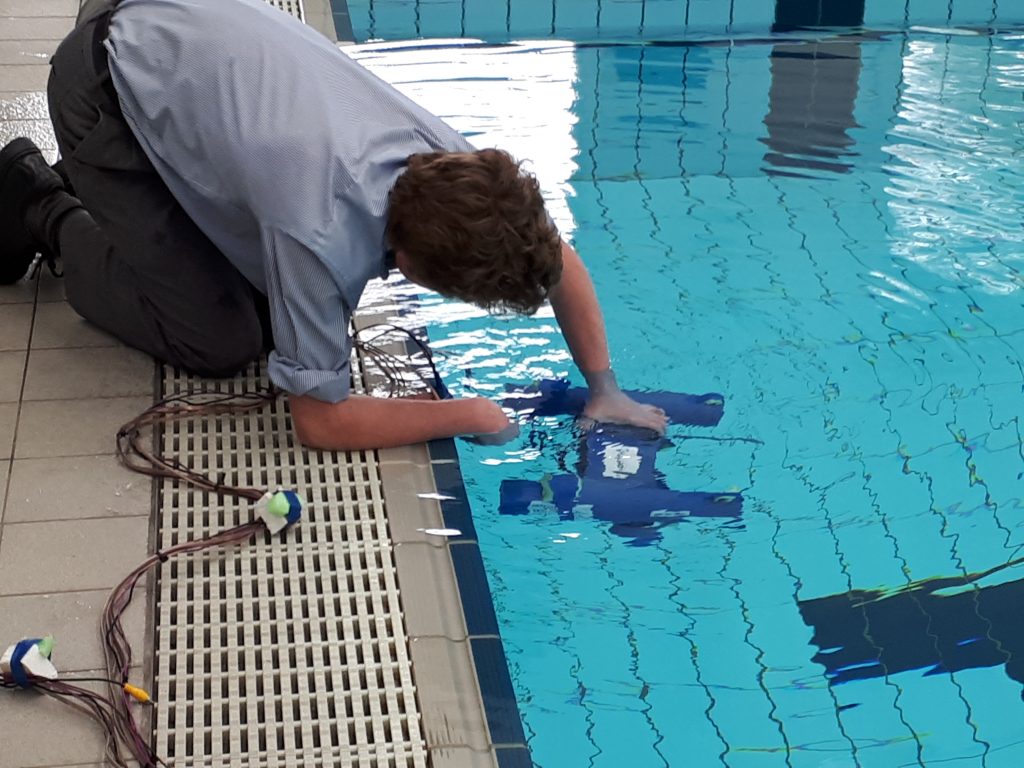 Students with their Remote Operated Underwater Vehicles at the Saints pool