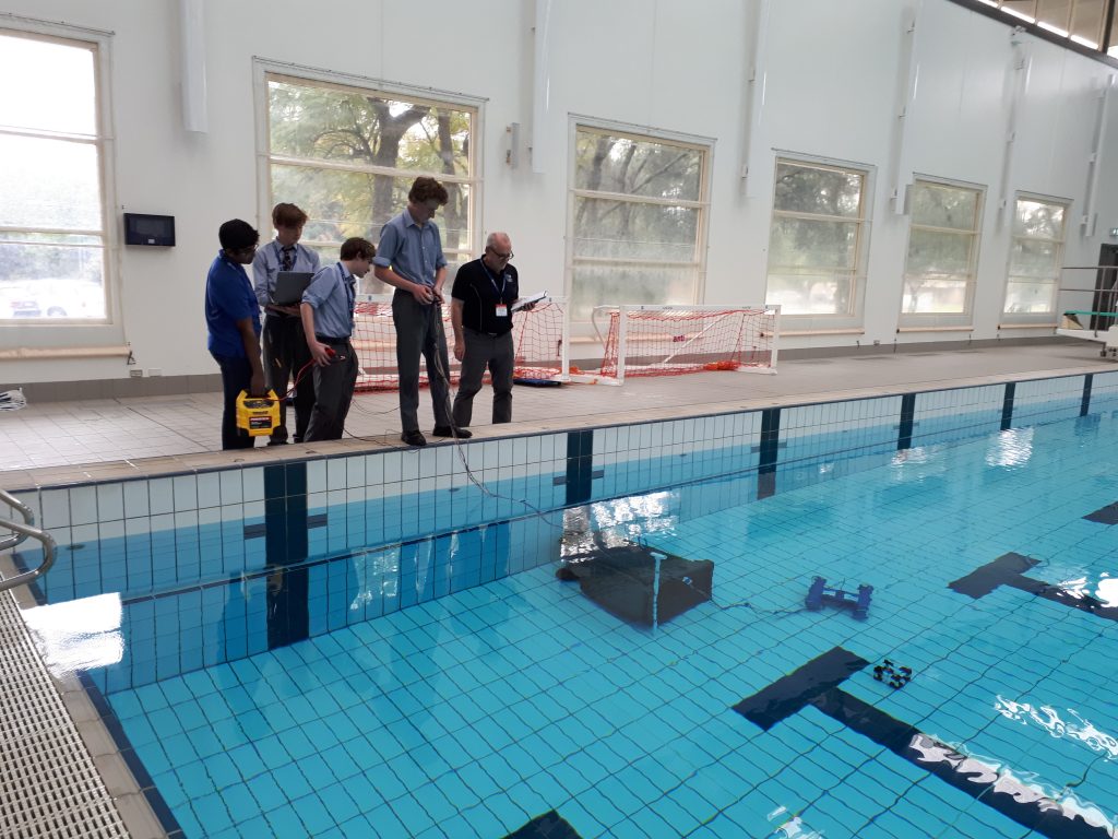 Students with their Remote Operated Underwater Vehicles at the Saints pool